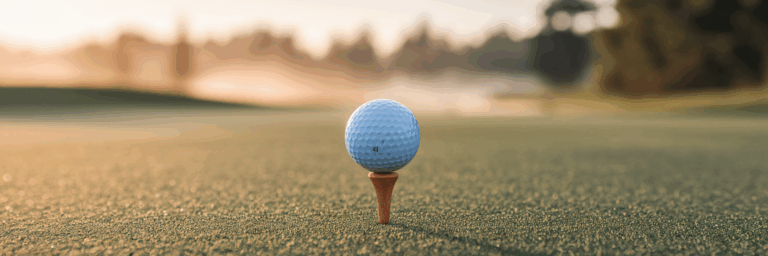 Pristine golf ball on a tee at sunrise.